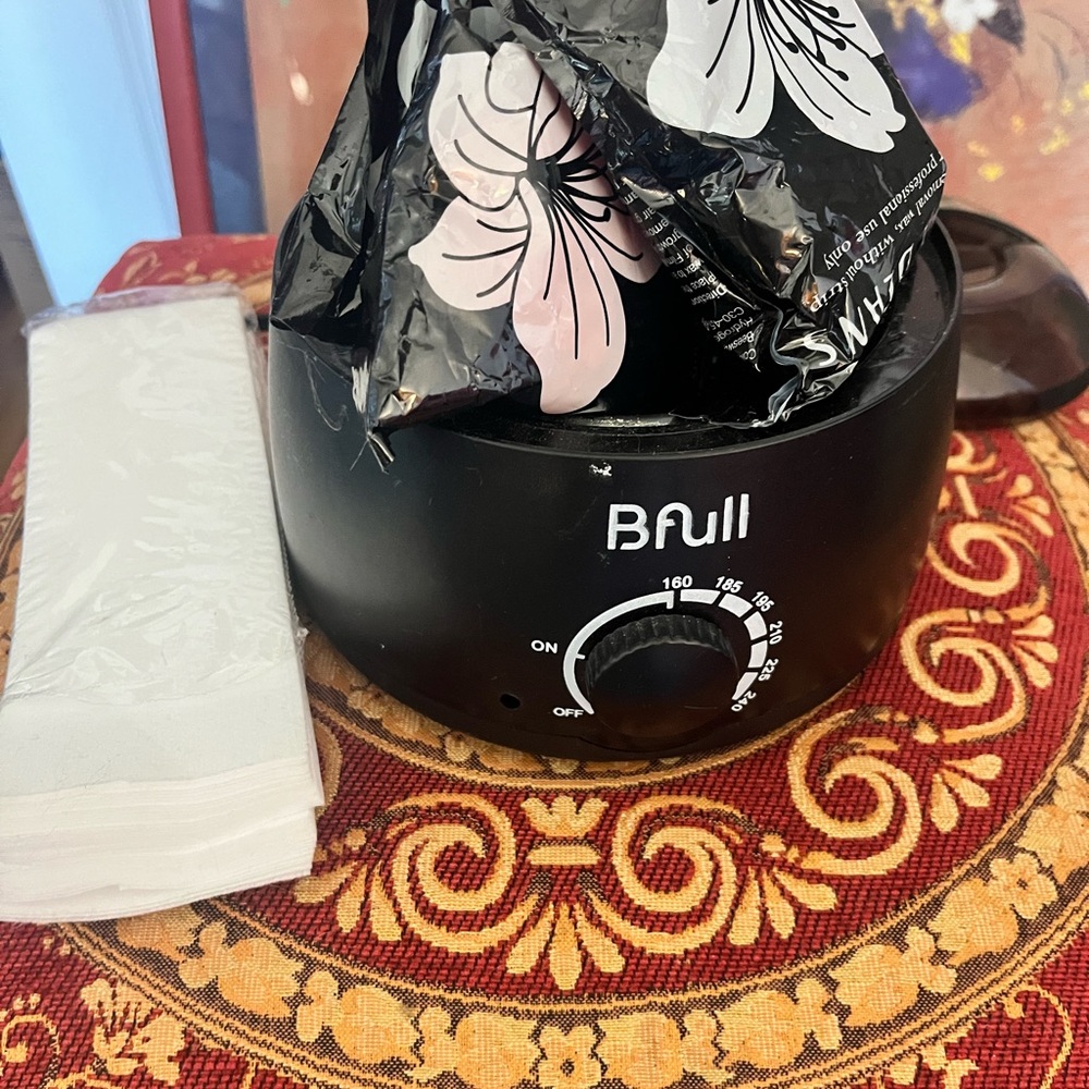 Black home waxing kit with supplies
